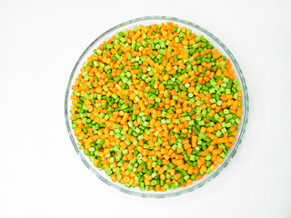Top view, masterbatch granules, polymer carrying pigment poured into a glass cup forming a circle with a white background, as a product catalog design for a plastic industry company profile