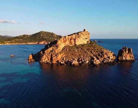 Coastal rock formation, sunlit cliffs