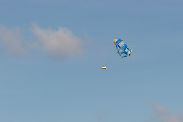 parasailing sports with blue cloudy sky at background in cancun mexico