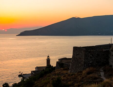 Coastal sunset with lighthouse and fortress