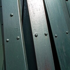 Obraz premium Close-up of textured wooden panels with rivets