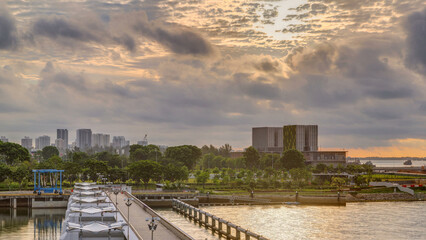 Beautiful sunrise at Marina Barrage timelapse. Orange sky and clouds with sun beams.