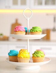 Colorful cupcakes on a tiered stand in a kitchen