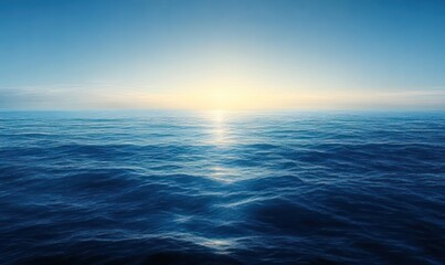 Fototapeta premium Calm ocean waves under a clear blue sky with warm sunlight reflecting on the water during sunrise or sunset
