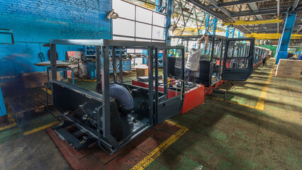 Conveyor assembly stage the body of tractor at big industrial factory timelapse
