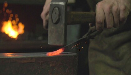 Blacksmith forging a glowing metal blade in workshop