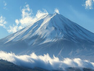 Snow-capped mountain peak under a blue sky with scattered clouds and mist rolling over the forested lower slopes
