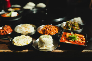 Grilled Korean beef short ribs (galbi) with caramelized edges on hot grill, served with lettuce wraps and kimchi, authentic Korean barbecue dining experience, overhead view.