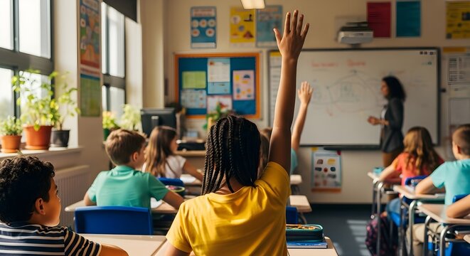 Diverse elementary school students raising hands to answer questions during a lesson with a teacher at the whiteboard