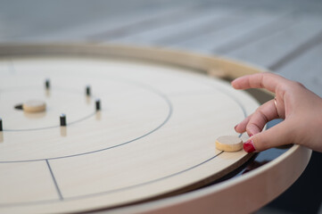Obraz premium Strategic Game Pieces on a Wooden Board crokinole. 