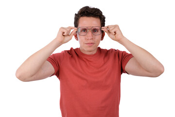 Fototapeta premium Man wearing a red shirt on a white background putting on glasses