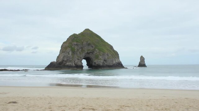 Majestic Rock Formation Amid Sandy Beach