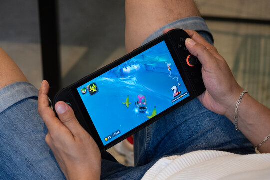 a man playing video games into a nintendo switch 2 system