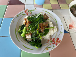 fried crispy pork with vegetables in a white plate