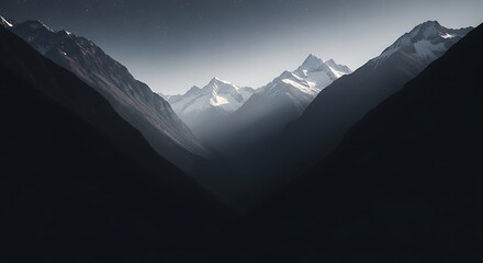 Obraz premium Majestic Mountain Peaks in a Misty Valley.