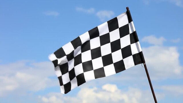 Checkered flag waves against a bright sky