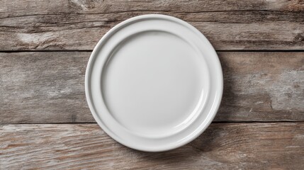 White ceramic plate with smooth rim on aged wooden planks. Top view