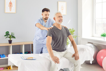 Doctor physiotherapist performs a back massage for an senior patient during a rehabilitation session. The physical therapy aids in recovery, offering therapeutic care for improved mobility.