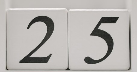 Close-up view of the number 25 in black text on a white background, perfect for calendar dates or countdown concepts. Close-Up of Number 25 on White Background for Calendar or Countdown Concept