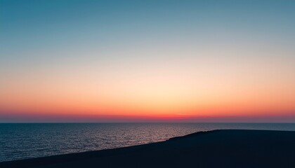 Obraz premium Serene Coastal Sunset with Ocean and Dunes