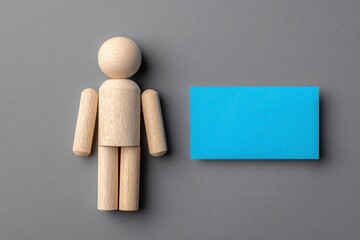 Wooden figure beside a blue note