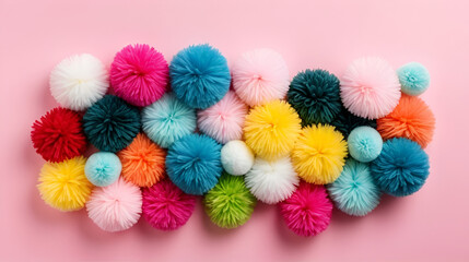 Colorful soft pom pom balls on pink background