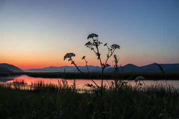 Obraz premium Beautiful sunset over the river. Traveling through wild places. Taiga.