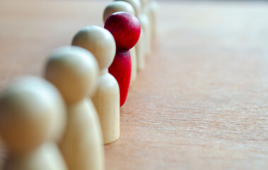 A red figurine stood up representing courage to speak up.