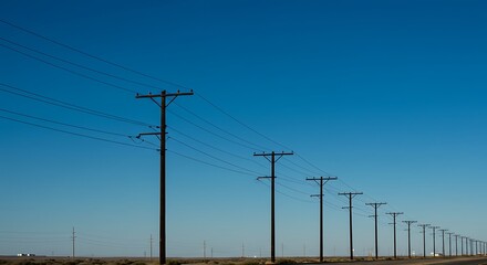 Powerline poles across open landscape