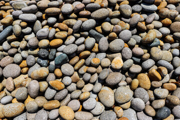 Large round sea stones. Rocky shore by the sea. Outdoor recreation.