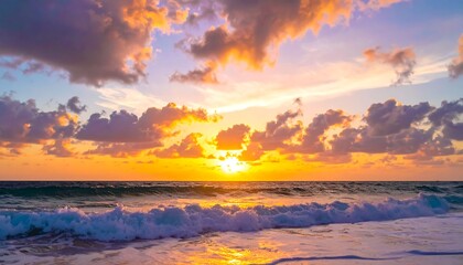 Obraz premium Vivid seascape captures a vibrant sunrise. Waves crash on sandy shore under a colorful, cloudy sky. Bright orange hues dominate
