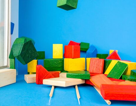 Colorful wooden blocks in a pile against a blue backdrop