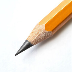 Close-up of a sharpened wooden pencil with a black graphite tip on a white background