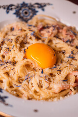 Noodles plate. Tasty macaroni. Traditional pasta cooked with grated cheese raw egg yolk. Italian cuisine carbonara recipe for delicious dinner.