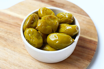 Pickled olives with a salty and slightly sour taste.