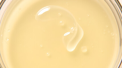 The texture of a cosmetic serum or body gel in a Petri dish.
