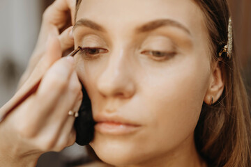 Applying eye makeup. Creating model image
