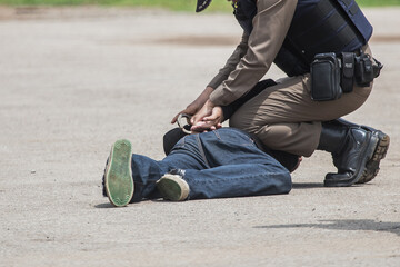 "Police Catch the Culprit",Police steel handcuffs,Police arrested,Professional police officer has to be very strong,Officer Arresting.