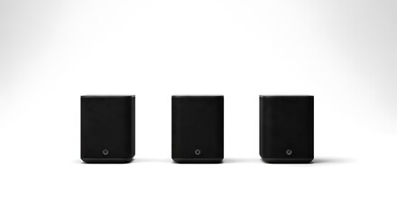 Three compact black sound speakers with minimalist design and subtle branding, arranged neatly on a clean white background, audio technology.