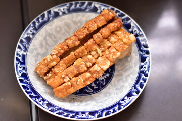 Crispy fried pork on white plate, Delicious glazed pork belly with crispy skin, Crispy Pork