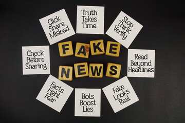 Fake News and Tips for Prevention written on sticky note on black background