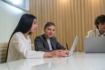 Diverse tech team meeting on software project, mentor guiding coworker on laptop, teamwork development using collaboration tools, modern technology, app design, dev training and enterprise SaaS team