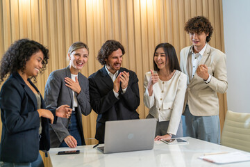 Diverse group business in formal attire smiling and clapping during a corporate meeting, celebrating success and achievements, diverse workplace environment with professional women engaged in teamwork