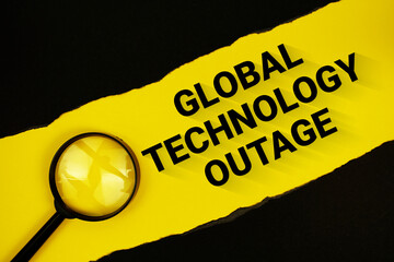 Global Technology Outage text on yellow with black paper torn ripped and magnifying glass
