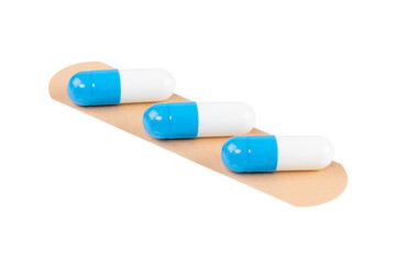 Adhesive bandage with blue and white capsule pills, isolated on white background with clipping path.