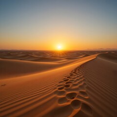 Golden sunset over desert with sand dunes and clear sky, natural landscape