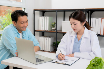 Asian nutritionist consulting patient in clinic, meal plan discussion, healthcare advice, weight loss support, doctor talking and explaining patient for nutrition consultation, wellness care.
