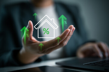 Housing market, real estate trend and loan interest concept. Real estate interest rates increasing, floating house icon with percentage signs and green upward arrows on businessperson's hand.