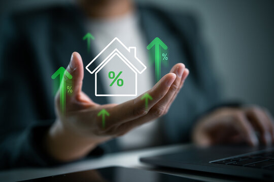 Housing market, real estate trend and loan interest concept. Real estate interest rates increasing, floating house icon with percentage signs and green upward arrows on businessperson's hand.