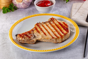 Tasty hot grilled bone steak served sauce
